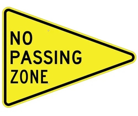 no passing zone sign on a road